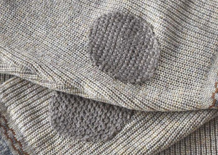 Elbows of the sweater mended with Scotch darning stitch