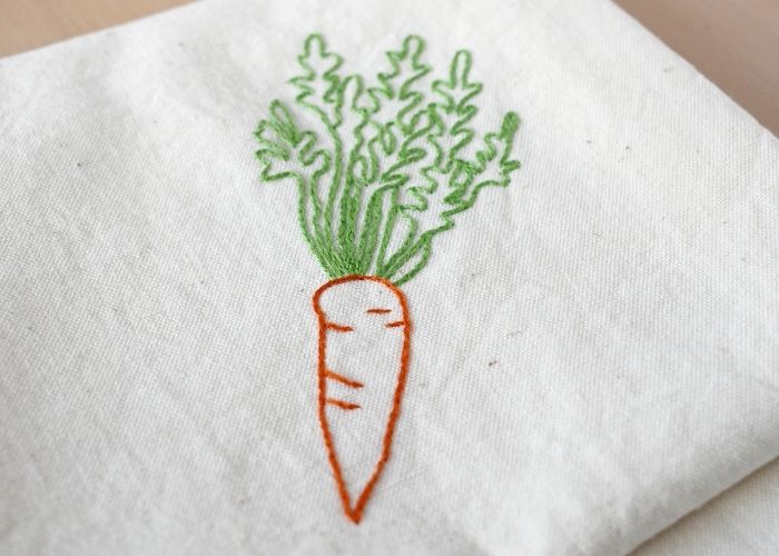 Carrot embroidery on tea towel